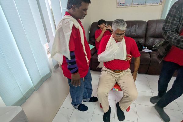 Basic Occupational First Aid Course hands-on CPR training AED demonstration during First Aid Course Malaysia Workplace safety first aid wound care session