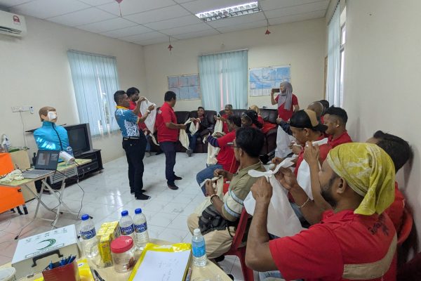 Basic Occupational First Aid Course hands-on CPR training AED demonstration during First Aid Course Malaysia Workplace safety first aid wound care session