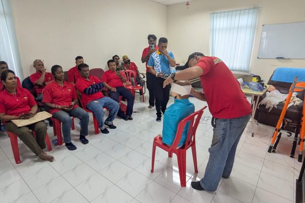 Basic Occupational First Aid Course hands-on CPR training AED demonstration during First Aid Course Malaysia Workplace safety first aid wound care session