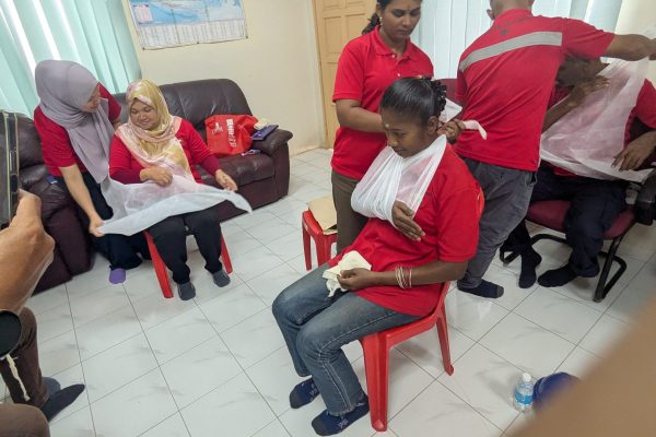 Basic Occupational First Aid Course hands-on CPR training AED demonstration during First Aid Course Malaysia Workplace safety first aid wound care session